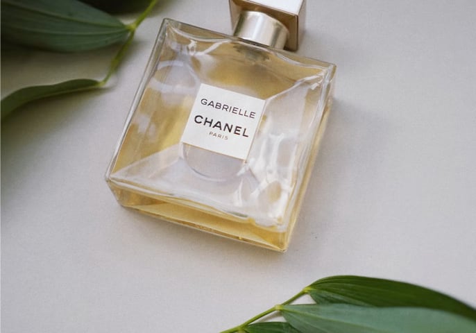 A square perfume bottle among the leaves